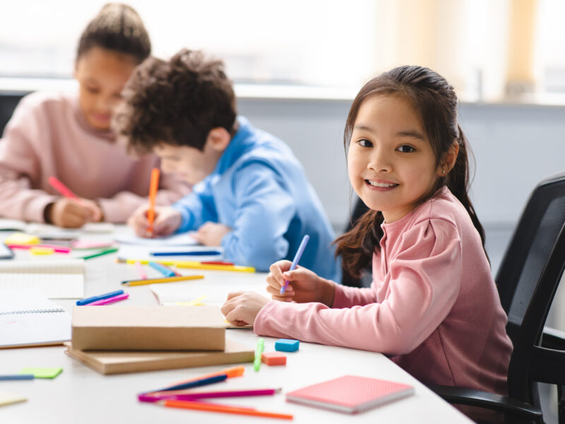 Elementary school student writing a response to a planning journal prompt.