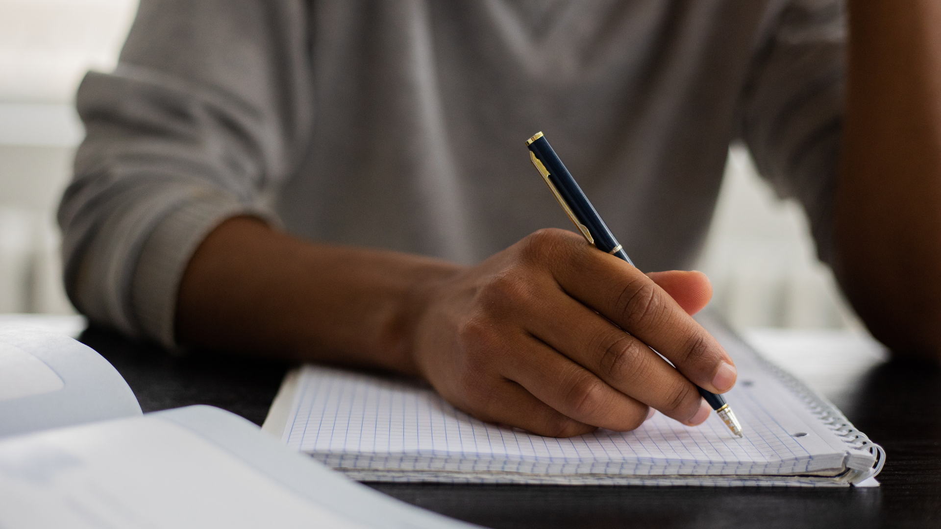 Student answering his metacognitive journal prompts in his notebook.